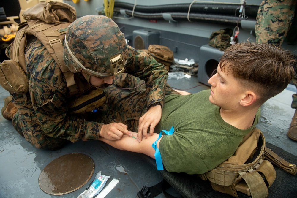 Hospital Corpsman Even James Provides Care to Marine