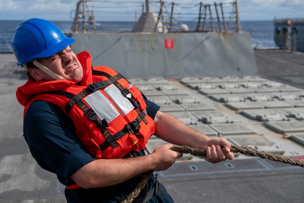 Sonar Technician (Surface) 2nd Class William Ford, from Mobile, Ala., heaves a line