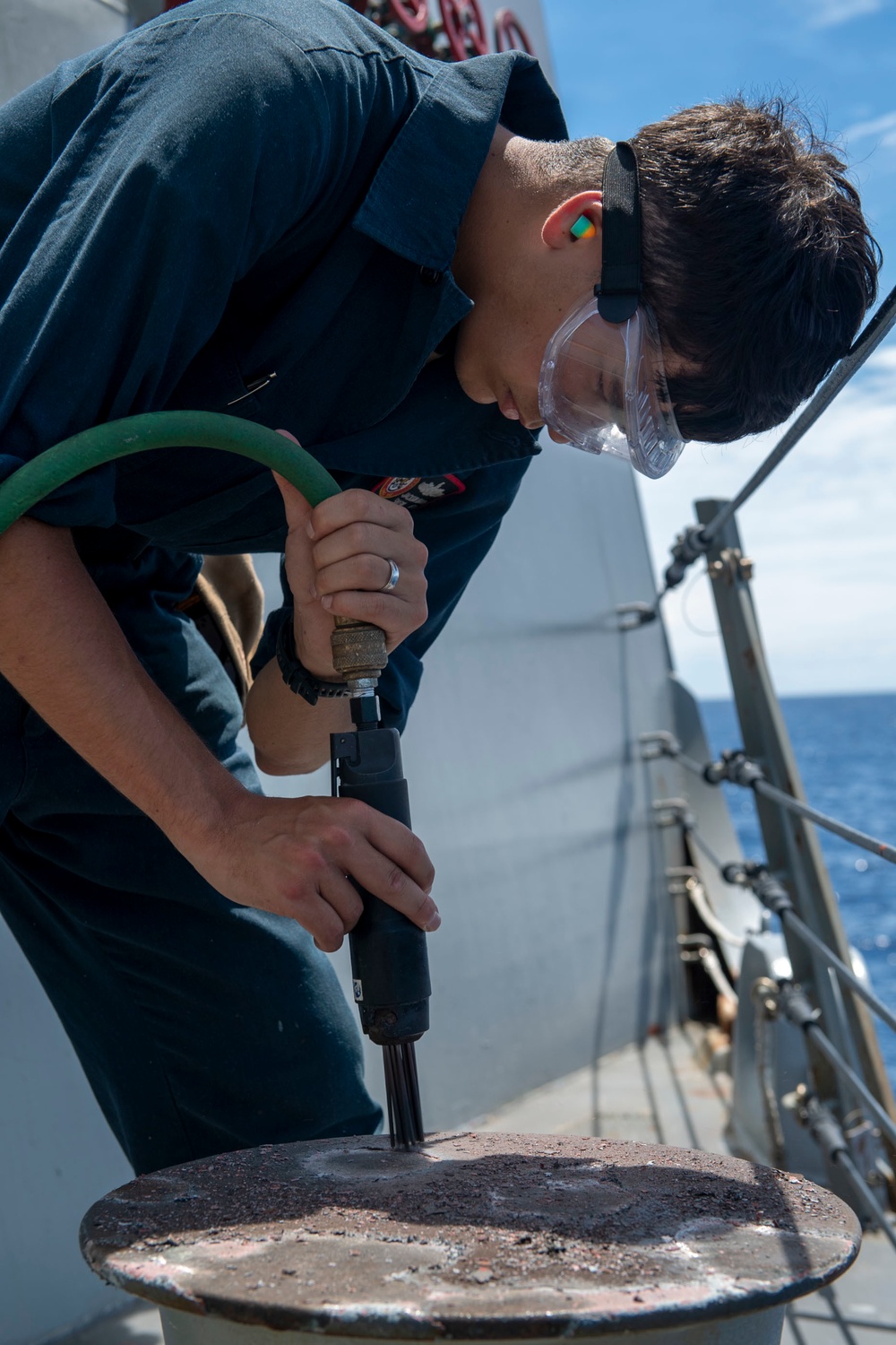 Seaman Isiah Jackson, from San Diego, Calif., conducts ship preservation