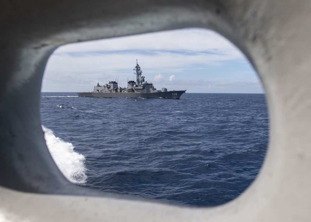 USS Rafael Peralta (DDG 115) sails alongside Japanese Maritime Self Defense Force Takanami-class destroyer JS Makinami (DD 112)