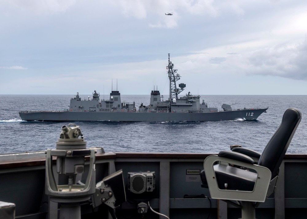 USS Rafael Peralta (DDG 115) sails alongside Japanese Maritime Self Defense Force Takanami-class destroyer JS Makinami (DD 112)