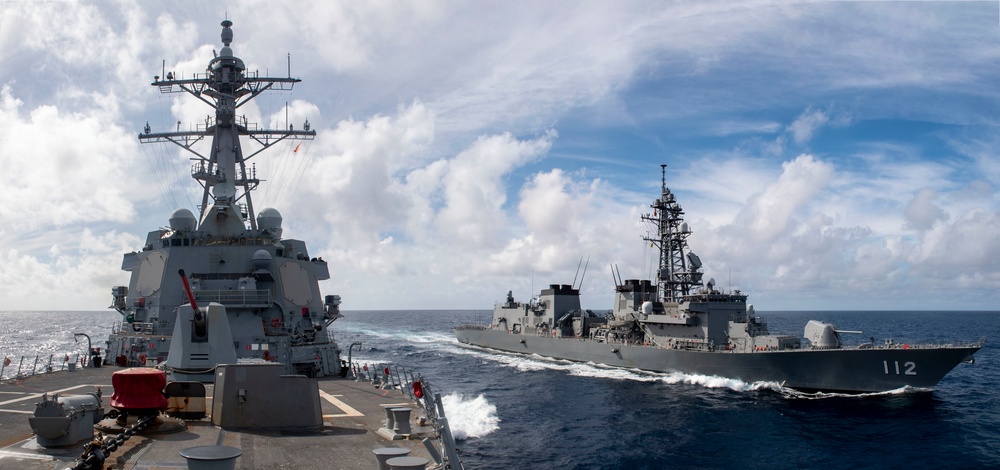 USS Rafael Peralta (DDG 115) sails alongside Japanese Maritime Self Defense Force Takanami-class destroyer JS Makinami (DD 112)