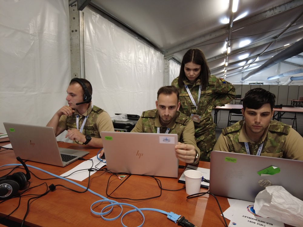 Romanian service members running tests on communication capabilities.