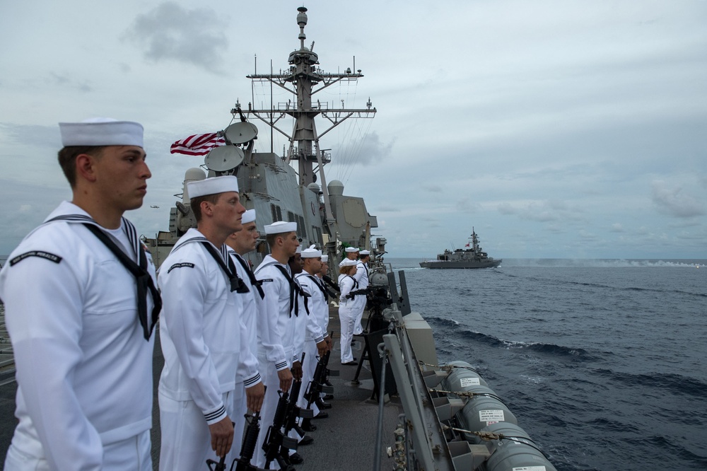 Sailors man the rails during a remembrance ceremony for the Solomon Islands campaign with Japanese Maritime Self Defense Force Takanami-class destroyer JS Makinami (DD 112)