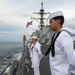 Sailors man the rails during a remembrance ceremony for the Solomon Islands campaign