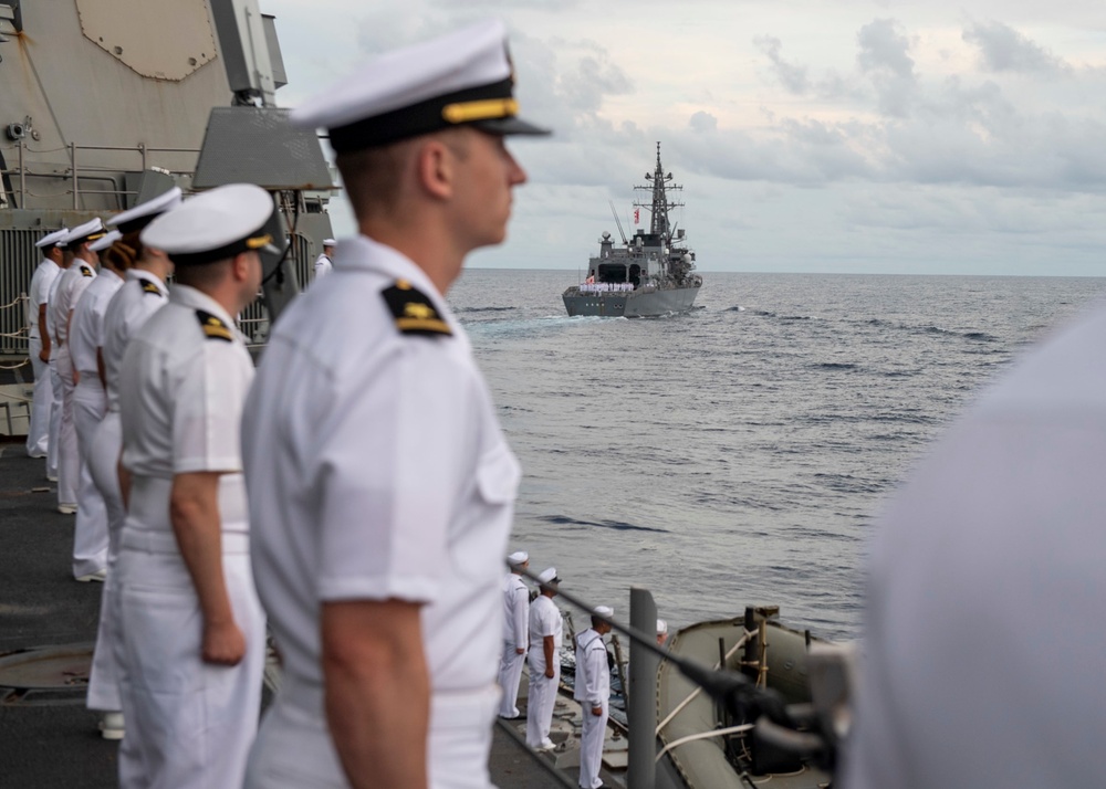 Sailors man the rails during a remembrance ceremony for the Solomon Islands campaign with Japanese Maritime Self Defense Force Takanami-class destroyer JS Makinami (DD 112)