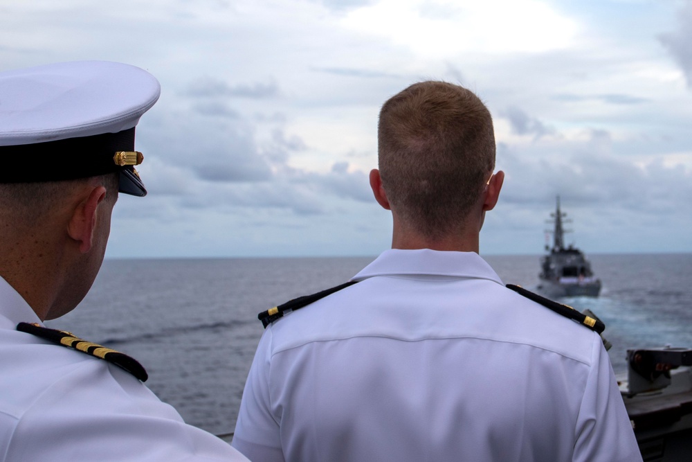 Cmdr. J.J. Murawski (left), commanding officer of USS Rafael Peralta (DDG 115), prepares for a remembrance ceremony for the Solomon Islands campaign with Japanese Maritime Self Defense Force Takanami-class destroyer JS Makinami (DD 112)