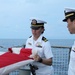 Sailors fold an American flag following a remembrance ceremony for the Solomon Islands campaign