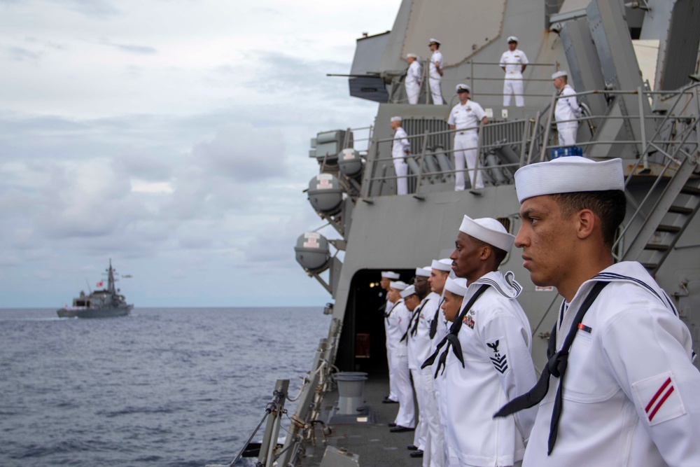 Sailors man the rails during a remembrance ceremony for the Solomon Islands campaign with Japanese Maritime Self Defense Force Takanami-class destroyer JS Makinami (DD 112)