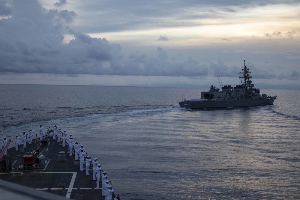 Sailors render honors for those lost during the during the Solomon Islands campaign during a remembrance ceremony with Japanese Maritime Self Defense Force Takanami-class destroyer JS Makinami (DD 112)