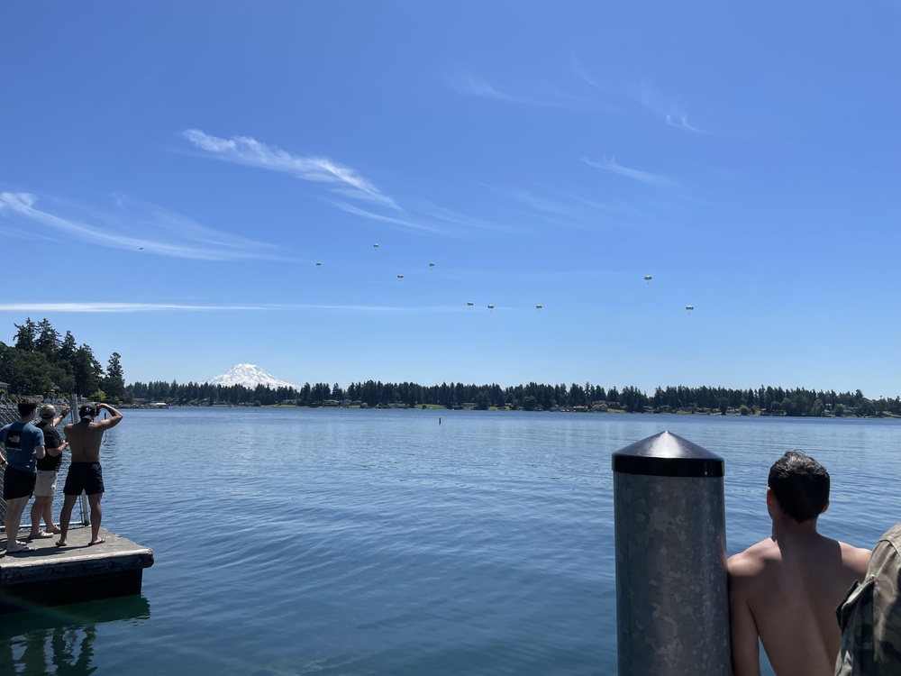 Curious onlookers observe airborne U.S. Army Rangers above American Lake