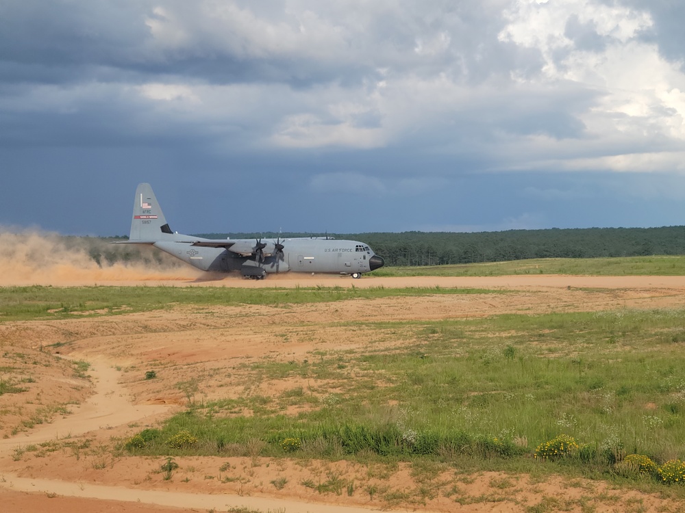 815th AS kicking up dust; letting cargo, personnel drop