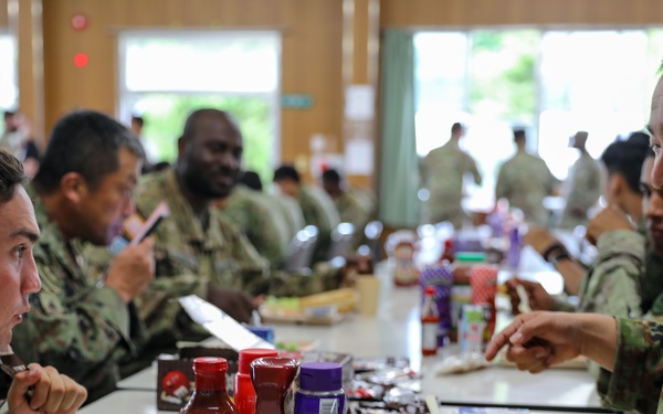 Dogface Soldiers and Japan Ground Self-Defense Force members enjoy dinner together during Orient Shield 21-2