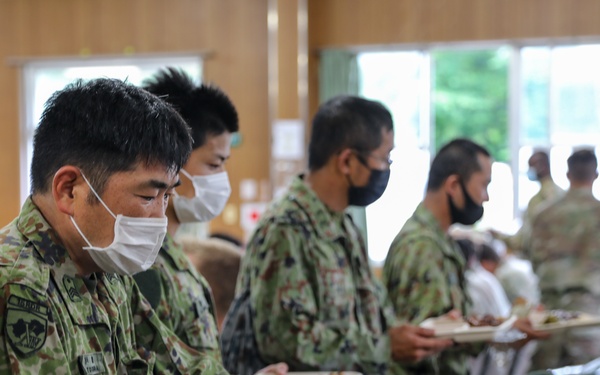 Dogface Soldiers and Japan Ground Self-Defense Force members enjoy dinner together during Orient Shield 21-2