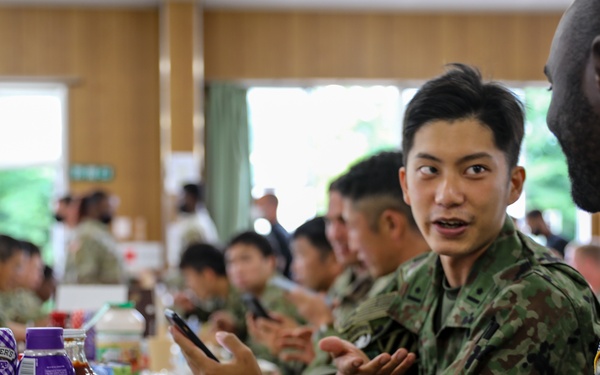 Dogface Soldiers and Japan Ground Self-Defense Force members enjoy dinner together during Orient Shield 21-2