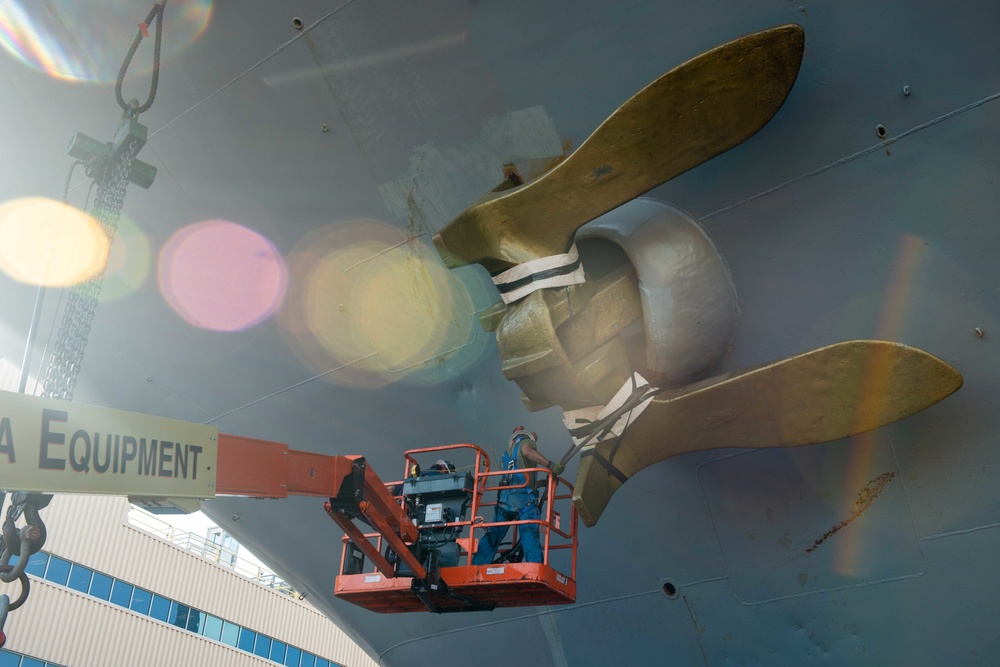 Newport News Shipbuilding contractors prepare to remove the anchor