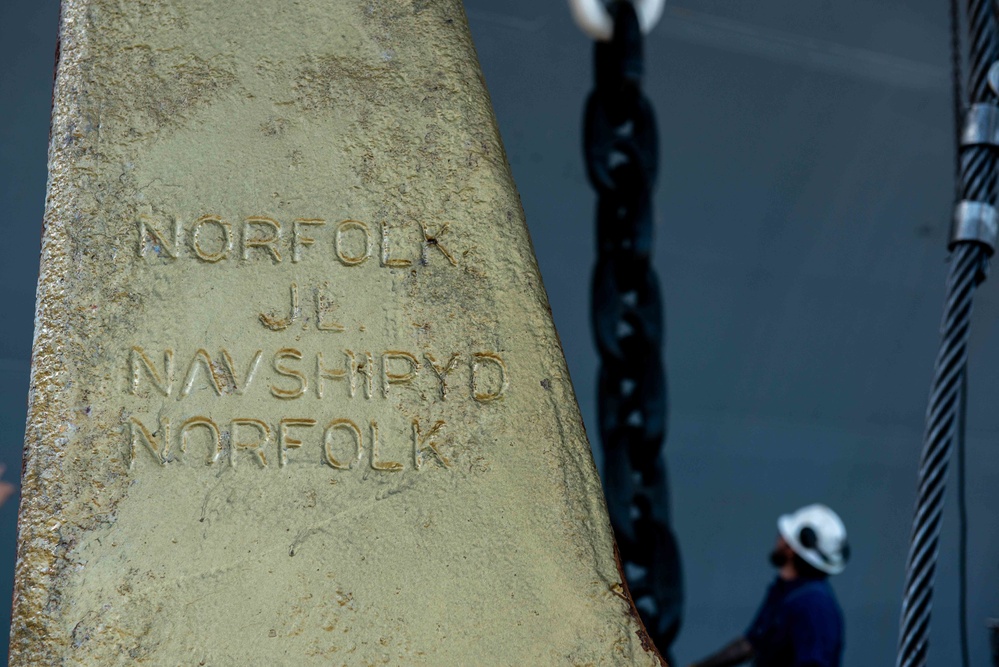 Newport News Shipbuilding contractors remove the anchor from the aircraft carrier USS John C. Stennis