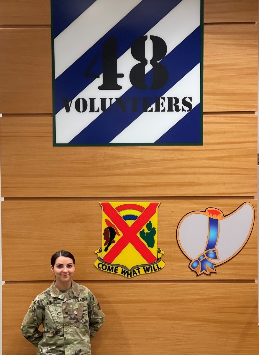 Georgia Guardsman poses in front of 48 IBCT insignia