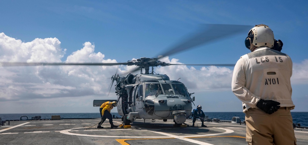 USS Billings Sailors Secure an MH-60S Sea Hawk Helicopter Upon Landing