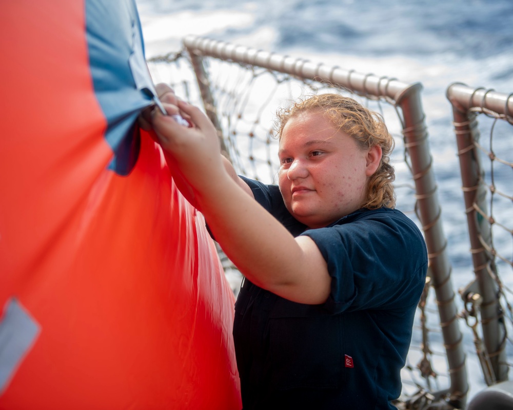 Gunner’s Mate Seaman Kayla Otten, from Murtle Beach, S.C., inflates a floating target