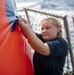 Gunner’s Mate Seaman Kayla Otten, from Murtle Beach, S.C., inflates a floating target