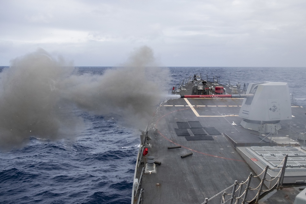 The Arleigh Burke-class guided-missile destroyer USS Rafael Peralta (DDG 115) conducts a live-fire exercise of the 5-inch gun