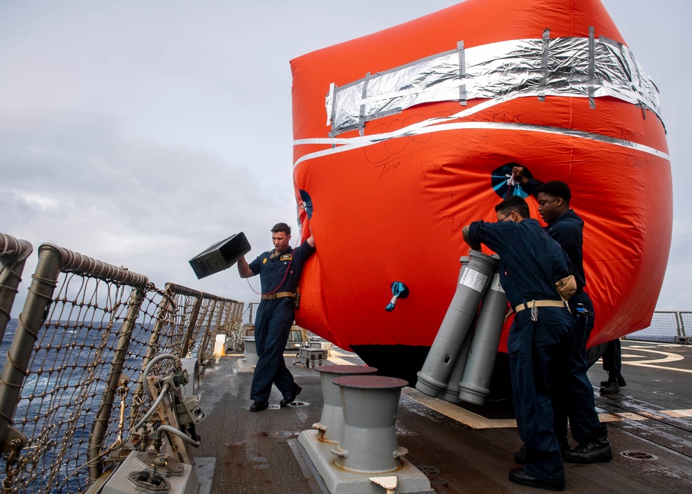 Sailors prepare to deploy a floating target