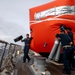 Sailors prepare to deploy a floating target