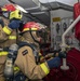 Sailors fight a simulated fire during a firefighting drill