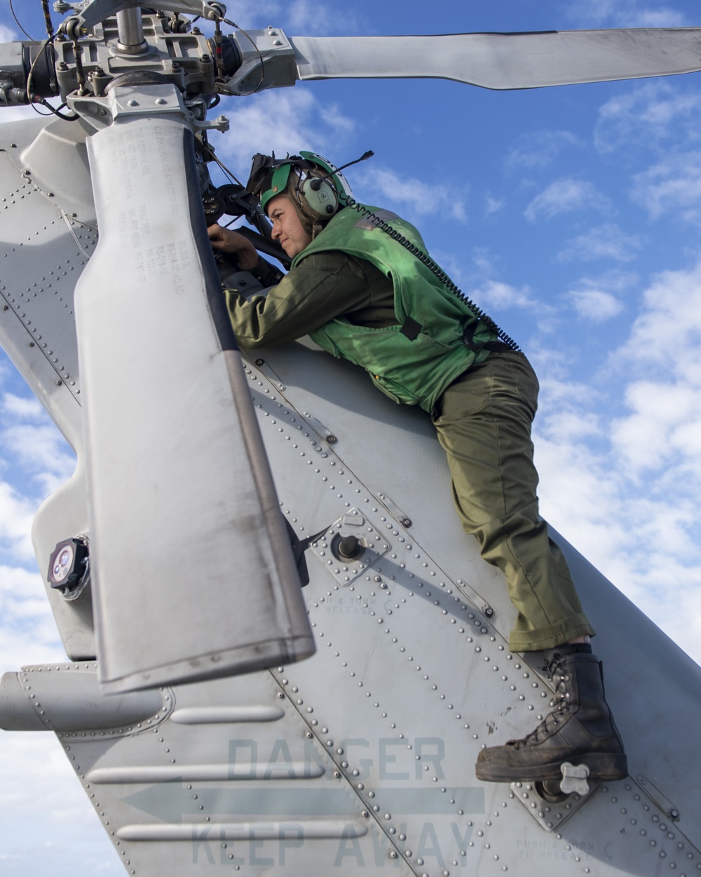 Aviation Electronics Technician 2nd Class Kayla Spencer, from Milton, Fla., conducts maintenance on a MH-60R Seahawk