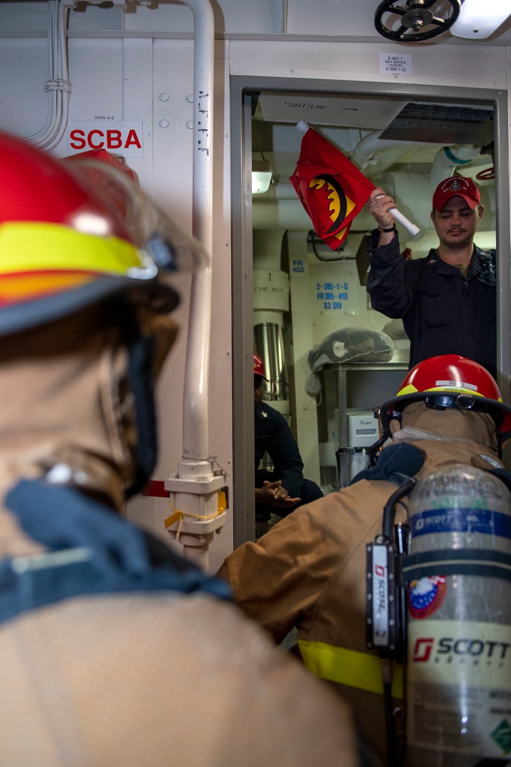 Sailors fight a simulated fire during a firefighting drill