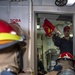 Sailors fight a simulated fire during a firefighting drill