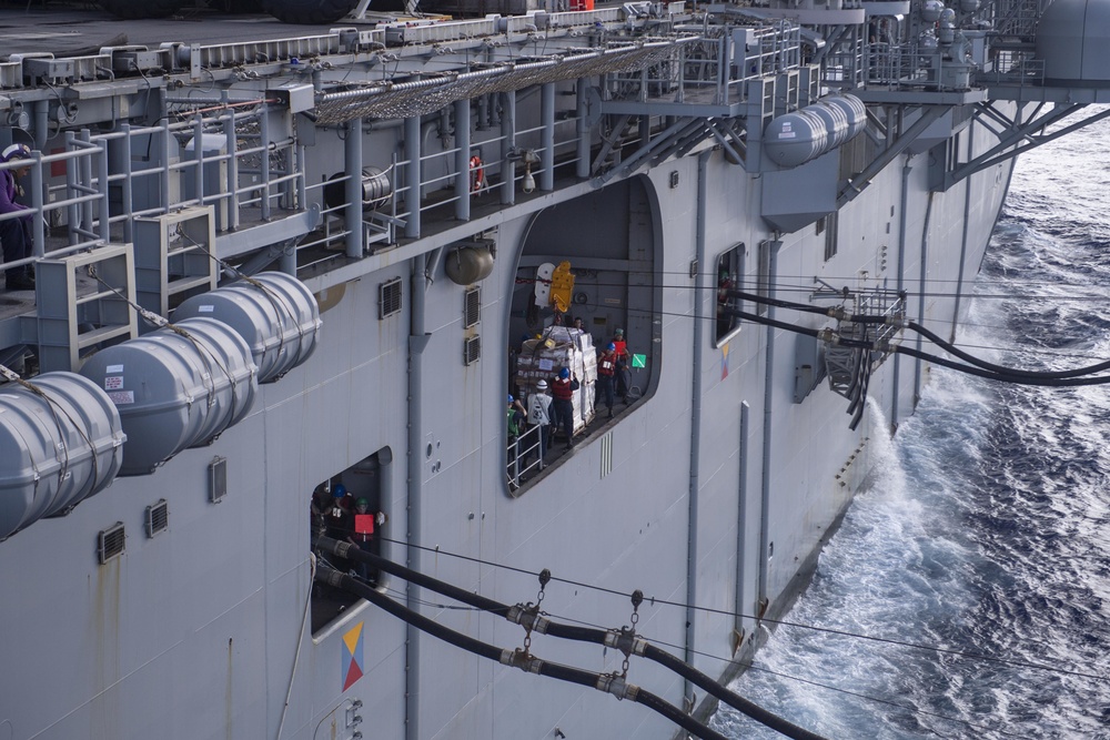 USS America conducts a replenishment-at-sea with the fleet replenishment oiler USNS Tippecanoe