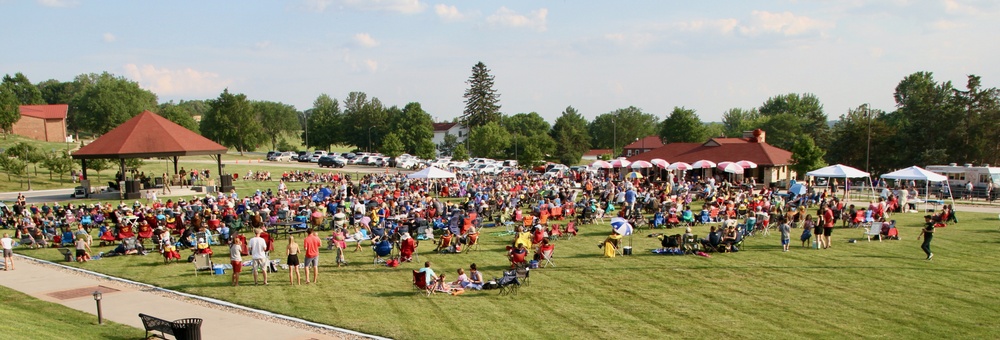 Iowans listen to the 34th Army Band, Sidewinders, Summer Concert Series concert at the historic Camp Dodge pool pavilion.