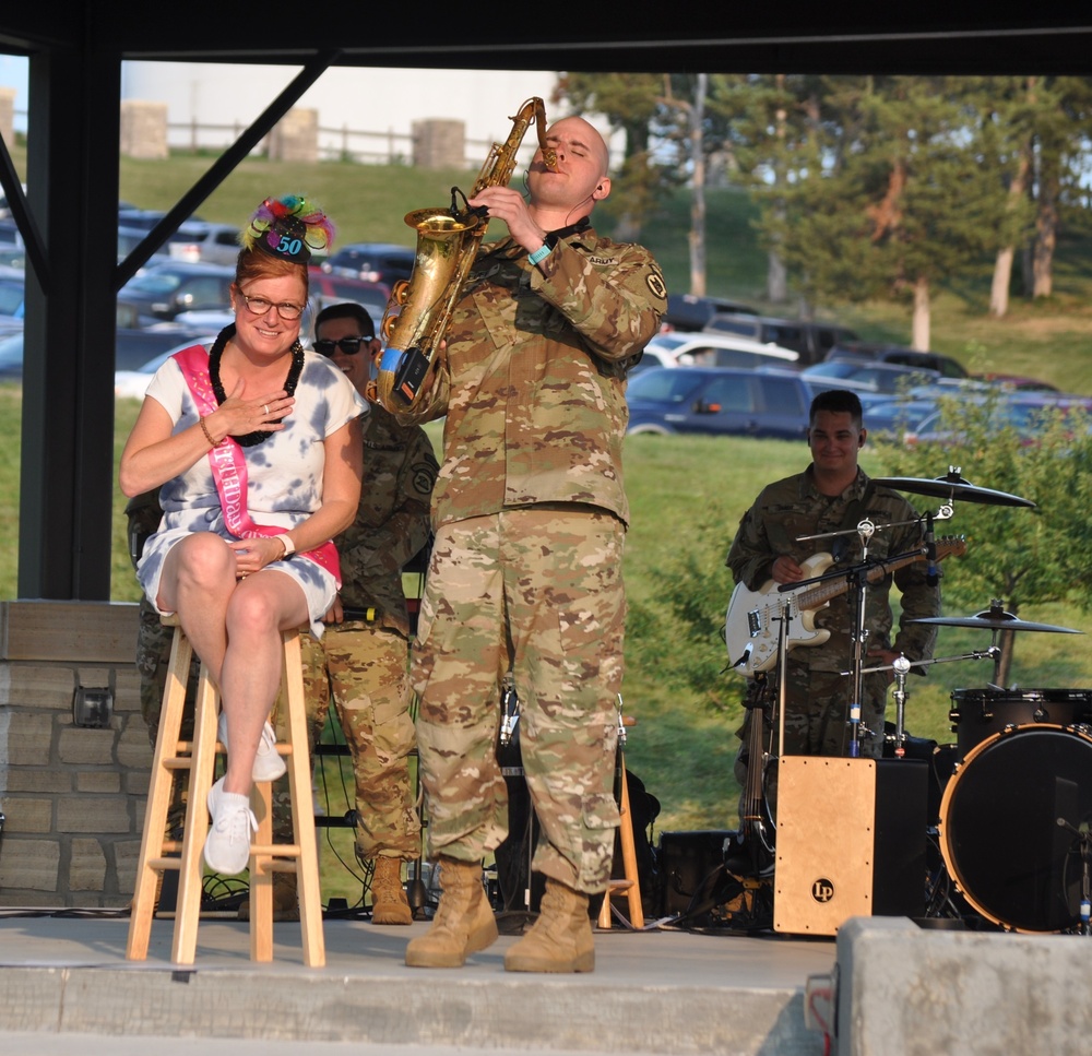 Spc. Jordan Elliff, musician with the 34th Army Band, Sidewinders serenades Lisa Fergus, from Johnston Iowa, with a with a rendition of Happy Birthday