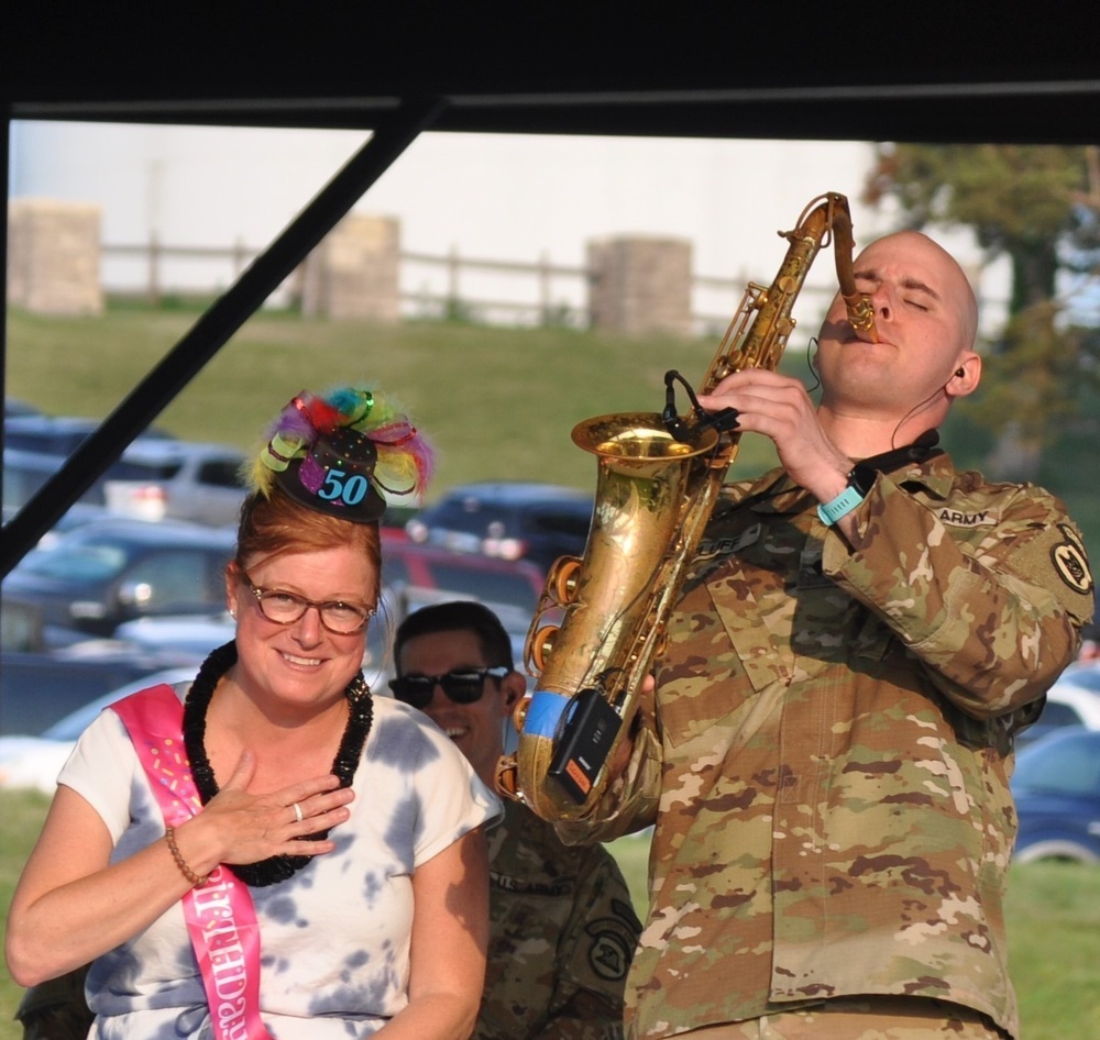 Spc. Jordan Elliff, musician with the 34th Army Band, Sidewinders serenades Lisa Fergus, from Johnston Iowa