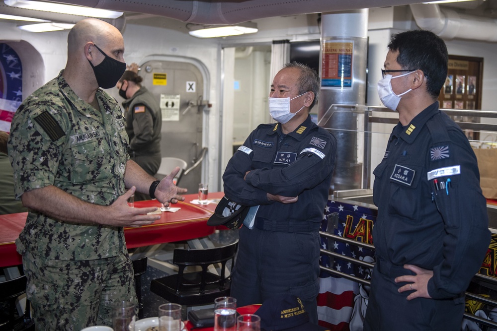 Cmdr. J.J. Murawski (left), commanding officer of USS Rafael Peralta (DDG 115), meets with representatives from the Japan Maritime Self Defense Force