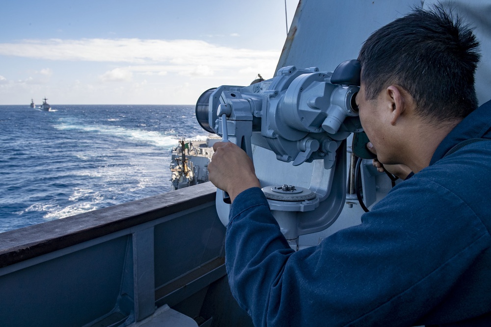Seaman Yi Zhou, from Los Angeles, Calif,. uses the big eyes