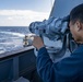 Seaman Yi Zhou, from Los Angeles, Calif,. uses the big eyes