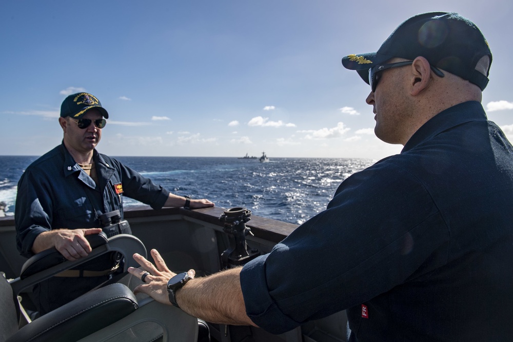 Cmdr. J.J. Murawski (right), commanding officer of the Arleigh Burke-class guided-missile destroyer USS Rafael Peralta (DDG 115), and Cmdr. Charles Cooper (left), executive officer, meet on the bridge wing