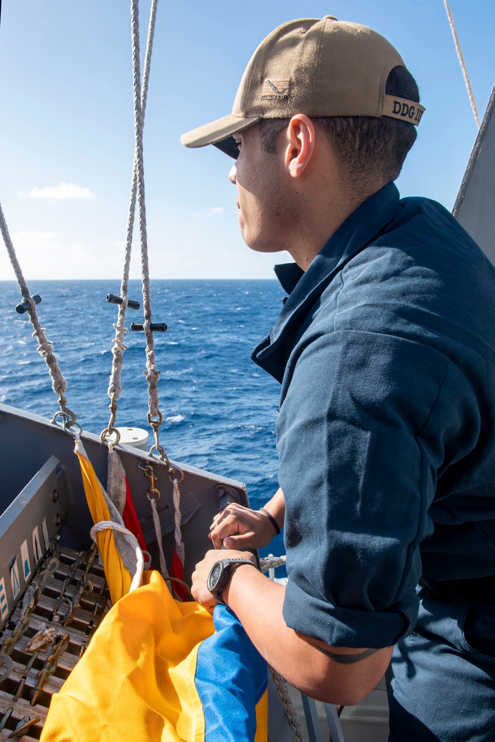 Quartermaster Seaman Morales Caceres, from Yabucoa, Puerto Rico, prepares to hoist a Quebec flag