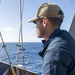 Quartermaster Seaman Morales Caceres, from Yabucoa, Puerto Rico, prepares to hoist a Quebec flag
