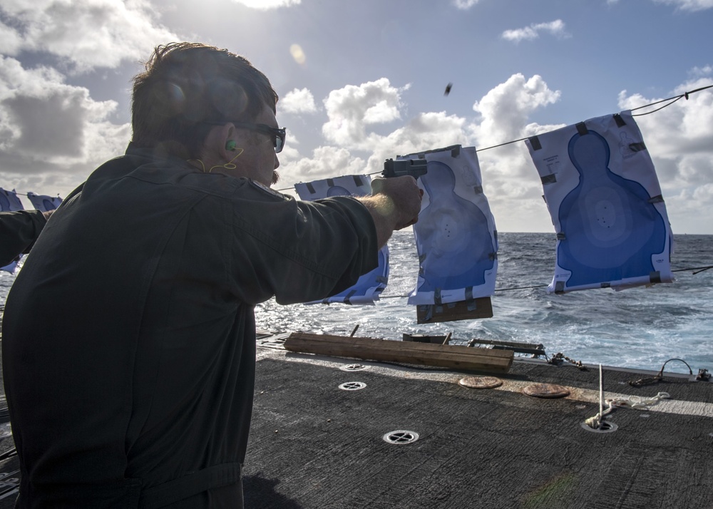 Lt. j.g. Nick Gizzi, from San Diego, Calif., fires an M11 pistol during a small-arms live-fire exercise