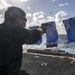 Lt. j.g. Nick Gizzi, from San Diego, Calif., fires an M11 pistol during a small-arms live-fire exercise