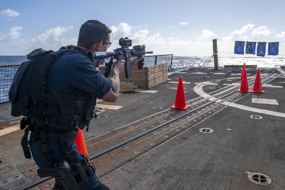 Chief Boatswain’s Mate Antonio Saiz, from Hutchinson, Kan., fires an M4 rifle during Visit, Board, Search and Seizure (VBSS) training