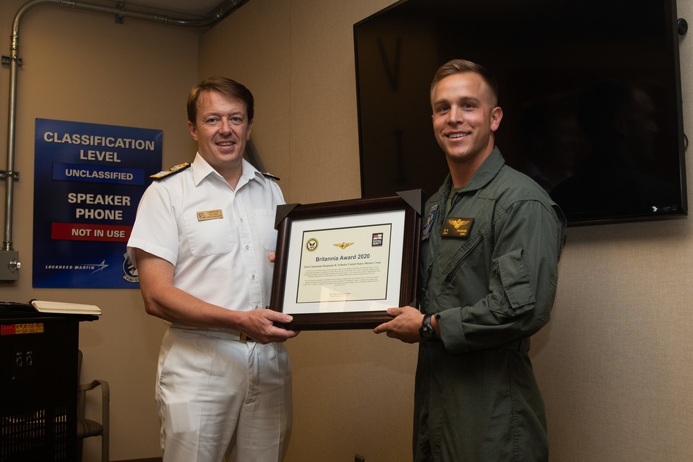 Royal Navy Commodore Phillip D. Nash presents the Britannia Award to 1stLt Benjamin Felhofer