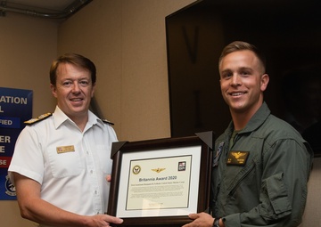 Royal Navy Commodore Phillip D. Nash presents the Britannia Award to 1stLt Benjamin Felhofer