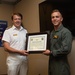 Royal Navy Commodore Phillip D. Nash presents the Britannia Award to 1stLt Benjamin Felhofer