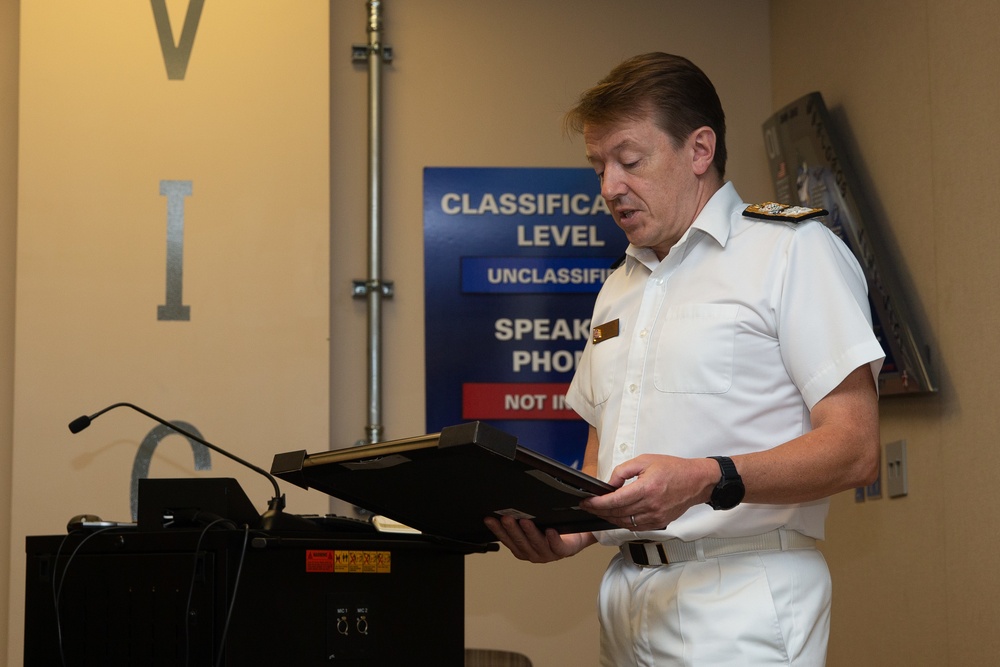 Royal Navy Commodore Phillip D. Nash presents the Britannia Award to 1stLt Benjamin Felhofer