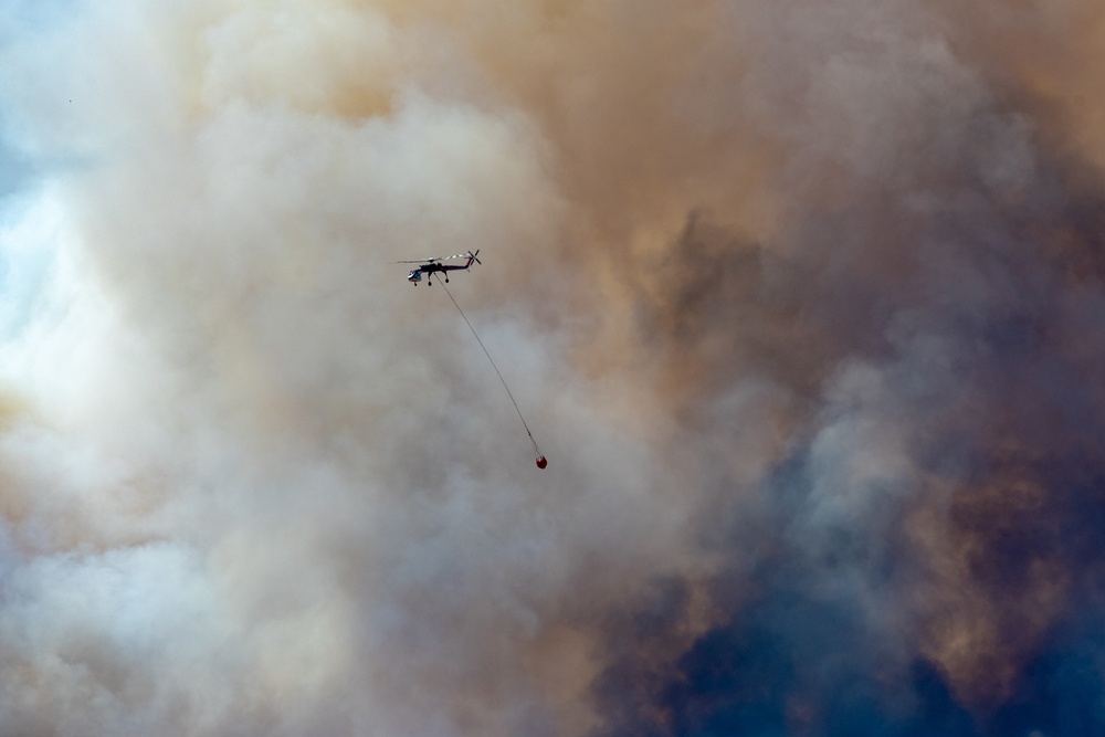 Helicopter drops water on the Beckwourth Complex Fire July 8, 2021 near Frenchman Lake in N. California